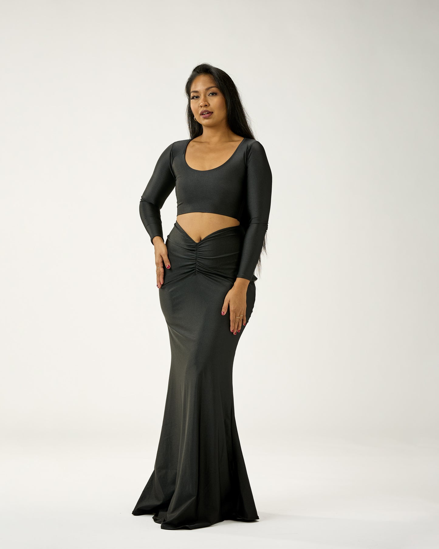 Woman wearing a black evening gown with a white background