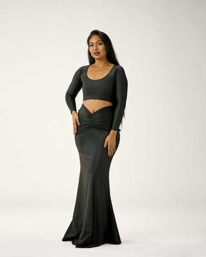 Woman wearing a black evening gown with a white background
