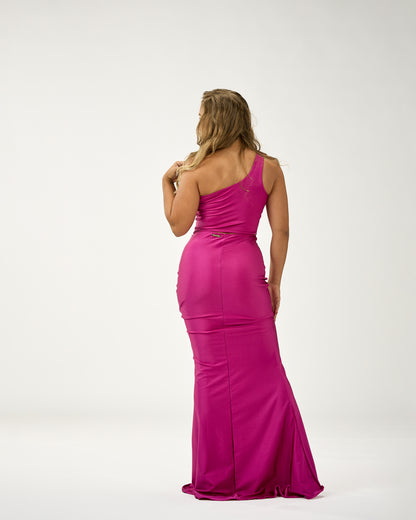 Woman wearing a pink evening gown on a white background