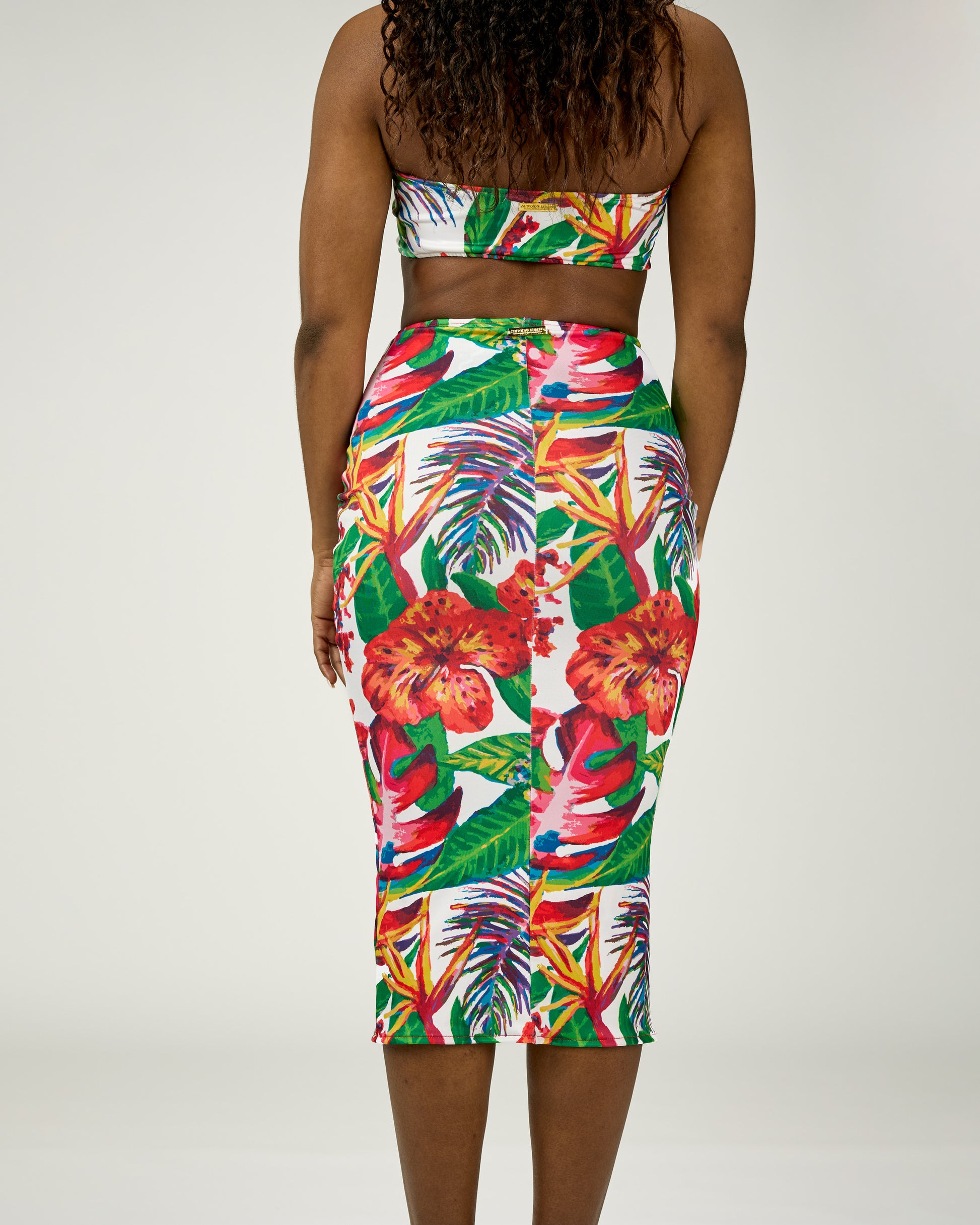 Tropical floral two-piece outfit on a plain background
